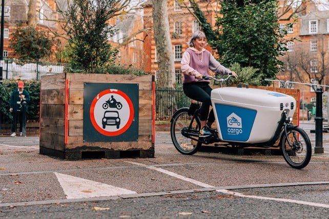 A person riding an ecargo bike in Hackney